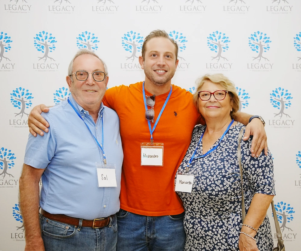 A family together in front of a legacy healing backdrop, creating a warm and inviting atmosphere. The scene captures a moment of connection and tranquility, contrasting with the chaos often associated with substance use and the adverse effects of when you party with drugs.