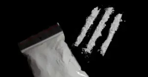 Powdered cocaine and lines representing the increased overdose risk from fentanyl exposure