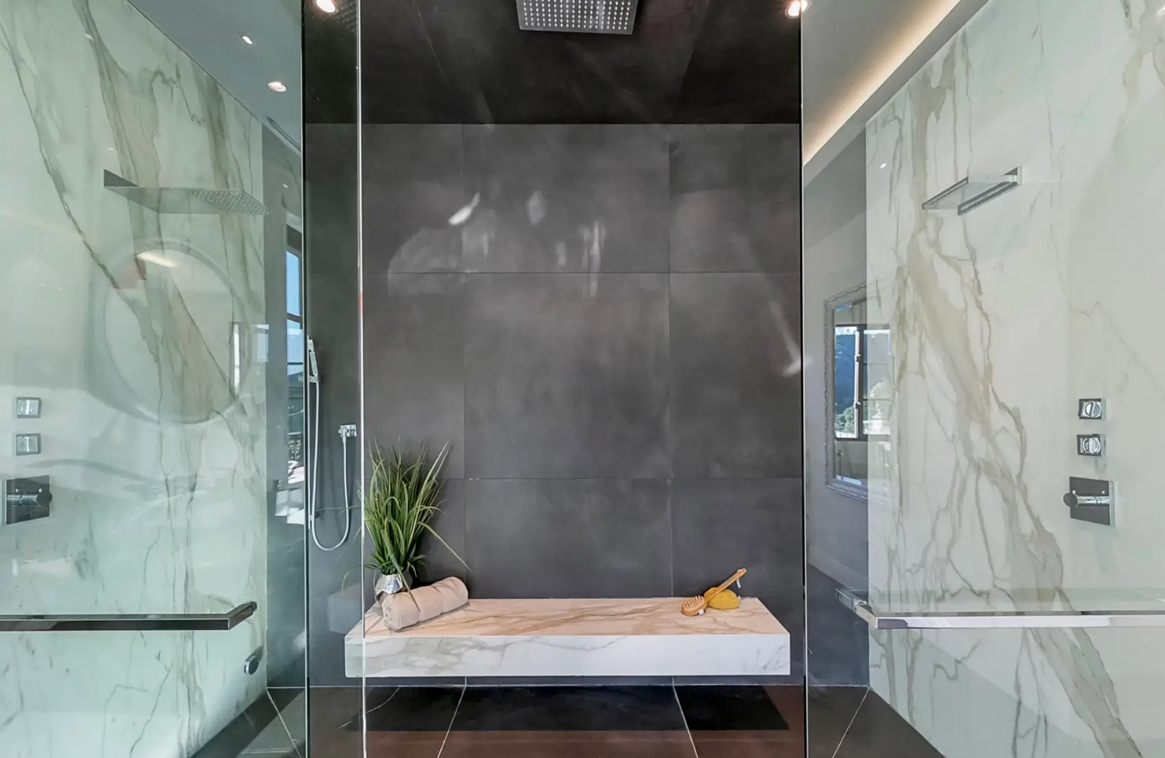 Modern spa-style bathroom with marble walls and walk-in shower at a Los Angeles luxury mental health and wellness retreat