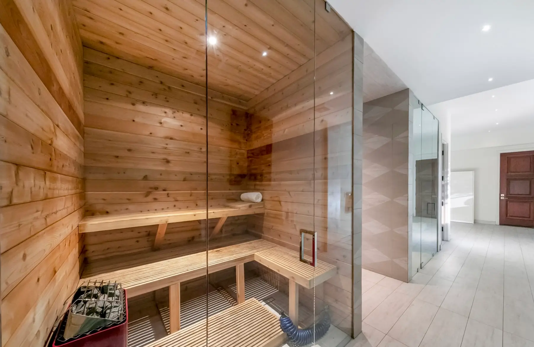 A serene indoor sauna and luxury spa amenities, with real wood and aromatherapy, creating a calming environment ideal for a luxury depression rehab retreat for anyone struggling with mental health disorders. This peaceful setting in a luxury mental health facility offers a supportive atmosphere for those seeking healing and recovery from depression and other mental health conditions.